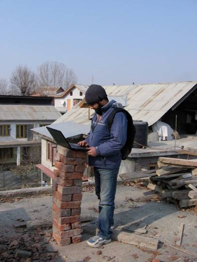Shahid, our IT consultant, at his first desk in our temporary roof office in Srinagar