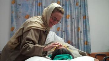 Treating a patient at the Government Psychiatric Hospital, Srinagar. Video still © Barbara Krieger